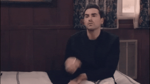 David Rose (Schitt's Creek) holds chin, deep in thought